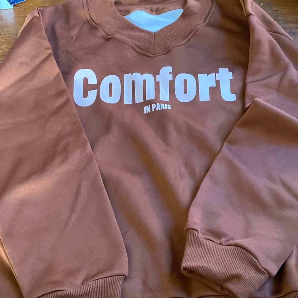 Size large brown sweat shirt, says comfort in Paris, super cute, never worn